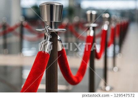 Red rope is tied to a metal pole Red rope is tied to a metal pole 129547572