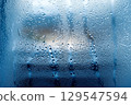 Condensation and frost on a winter window (AI-generated image) 129547594