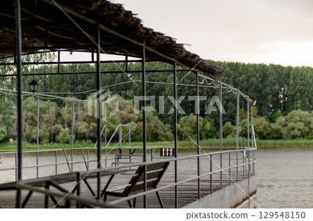 Wooden pier near the river close-up 129548150