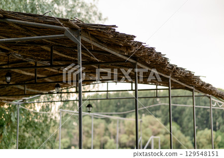 Wooden gazebo roof with thatched roof Wooden gazebo roof with thatched roof 129548151