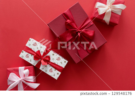 Border from Christmas gifts on a red background. 129548176
