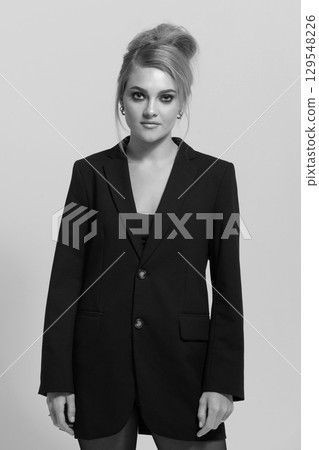 Beautiful woman with black suit studio portrait on white background Beautiful woman with black suit studio portrait on white background 129548226