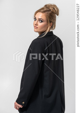 Beautiful woman with black suit studio portrait portrait on white background 129548227