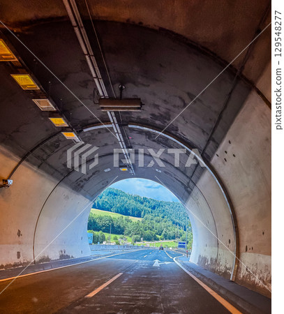 Perspective view from inside a tunnel looking out to a sunny landscape with hills and clear skies. High quality photo Perspective view from inside a tunnel looking out to a sunny landscape with hills and clear skies. High quality photo 129548277