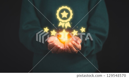 Person holding and showing the best quality assurance with golden five stars. Quality assurance of business services. Guarantee, Standards, ISO certification and testimonial concept. 129548570