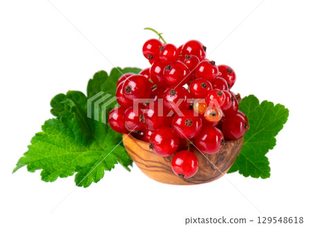 Red currant isolated on white background. Redcurrant or Ribes rubrum ripe berries with green leaves in wooden bowl. 129548618