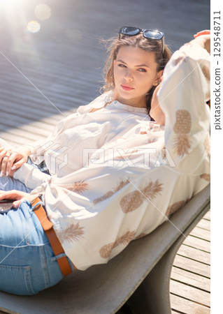 Two beautiful women having fun in city during sunny summer day Two beautiful women having fun in city during sunny summer day 129548711