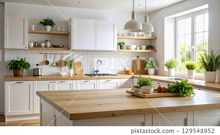 A kitchen with a wooden countertop and a large window. The kitchen is well-lit and has a clean, modern look. There are several potted plants throughout the space, adding a touch of greenery 129548952