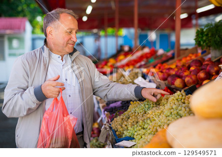 Middle aged man buying fruits 129549571