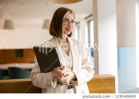 A skilled professional in a stylish modern office showcases expertise and unique presence 129549698