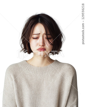 Portrait of a young Japanese woman crying and showing emotional expression, unable to hold back tears 129550218