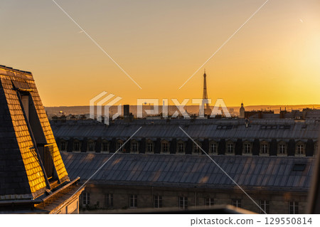 View of Paris and Eiffel Tower and rooftops from above. Beautiful sunset over Paris, France 129550814