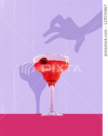 Colorful collage. Elegant red cocktail in margarita glass with cherry garnish and playful shadow on pastel background 129550867