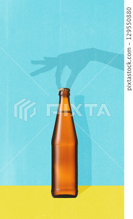 Colorful collage. Minimalist composition with brown beer bottle and playful shadow hand gesture on blue background 129550880