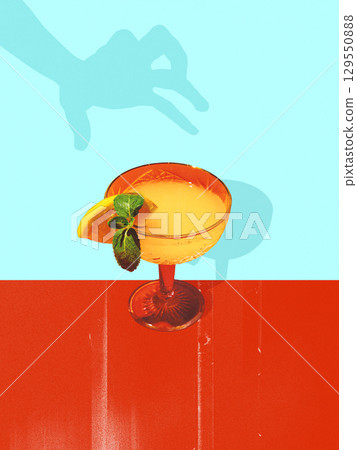Bold colorful poster. Orange cocktail with mint and citrus garnish on red and turquoise background 129550888
