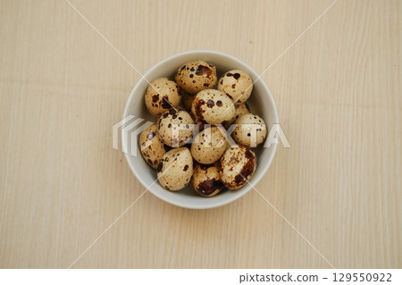 Fresh Quail Eggs on Wooden Table 129550922