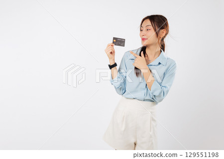 Happy asian woman hold credit card pointing finger, bank card solution, lady card concept showing benefits and money alternatives with debit card, isolated studio white background Happy asian woman hold credit card pointing finger, bank card solution, lady card concept showing benefits and money alternatives with debit card, isolated studio white background 129551198