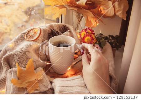 Cozy Autumn still life on the windowsill in the style of instagram. Cozy Autumn still life on the windowsill in the style of instagram. 129552137