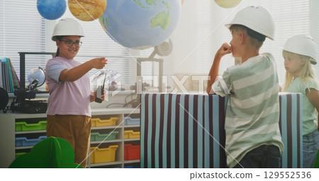 Elementary School Girl Giving Instructions for Urban Planning. Classroom STEM Activity Elementary School Girl Giving Instructions for Urban Planning. Classroom STEM Activity 129552536