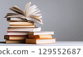 Open book and stack of hardcover books on the table. Concept back to school, education, library. 129552687