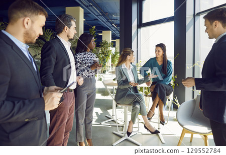 Office diverse business colleagues gathering in boardroom hall, female coworkers brainstorm  129552784