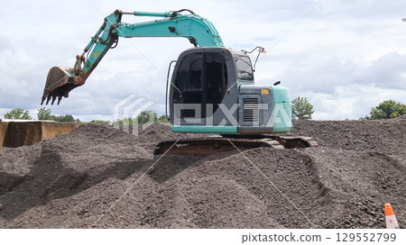 Excavator Digging Gravel Stones Close to the River 129552799