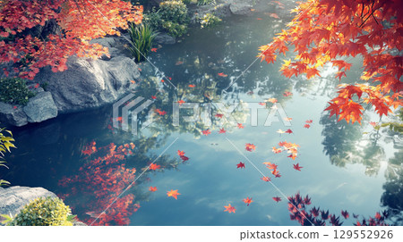 A tranquil scene of autumn leaves floating on a pond 129552926