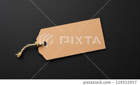 Brown Paper Tag with Twine on Dark Background Brown Paper Tag with Twine on Dark Background 129552957
