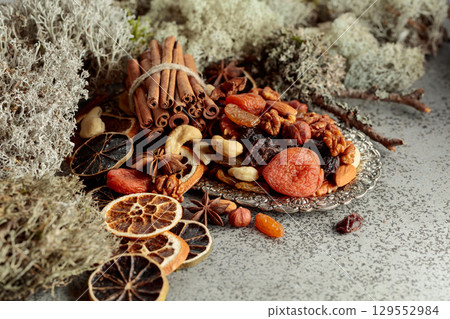 Dried fruits and nuts on a silver try. Dried fruits and nuts on a silver try. 129552984