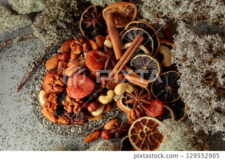 Dried fruits and nuts on a silver try. Dried fruits and nuts on a silver try. 129552985