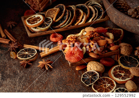 Dried fruits and nuts on a brown vintage background. Dried fruits and nuts on a brown vintage background. 129552992