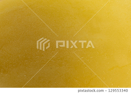 Macro slice of raw potatoes culinary natural yellow background. 129553340