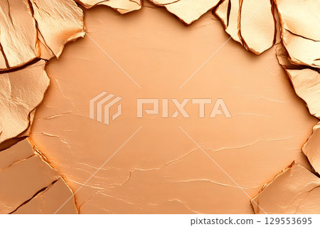 Detailed close up of a cracked arid and weathered desert surface texture with a warm earthy color palette 129553695