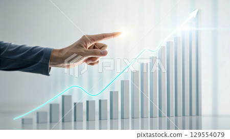 hand points towards rising graph symbolizing business growth and success. This captures essence of progress and achievement 129554079