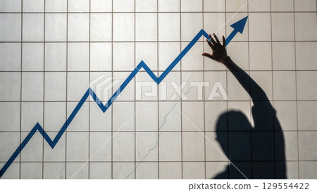 image depicts hand reaching towards upward trending graph, symbolizing business growth and success 129554422