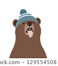 Playful bear catches snowflakes in cozy winter hat 129554508