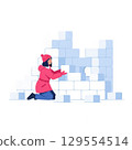 Child building snow fort in winter, playing outdoors in warm clothing 129554514