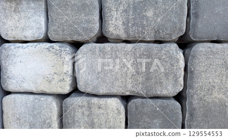 Close-up of gray cobblestone wall showing texture and pattern Close-up of gray cobblestone wall showing texture and pattern 129554553