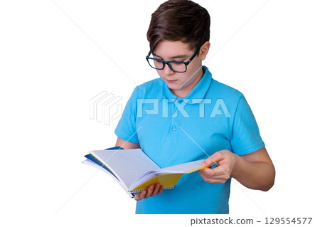 Caucasian male teen reading notebook in blue shirt isolated on white background 129554577