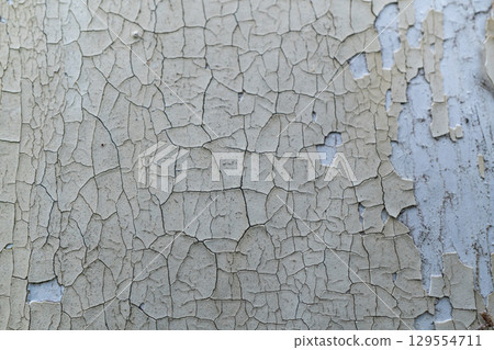 Close-up of weathered peeling paint on old wall surface 129554711