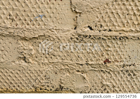 Texture of rough beige painted brick wall with weathered surface 129554736