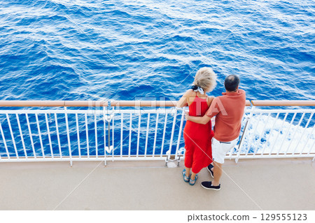 Couple in love on cruise ship. Man and woman in love enjoying their romantic vacation. High quality photo 129555123