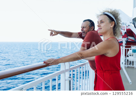 Married couple on cruise ship. Attractive couple on deck with cruise ship. High quality photo 129555216