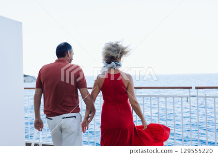Married couple on cruise ship. Attractive couple on deck with cruise ship. High quality photo 129555220