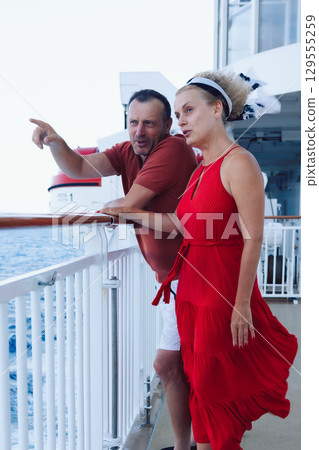 Couple in love on cruise ship. Man and woman in love enjoying their romantic vacation. Vertical photo. High quality photo 129555259