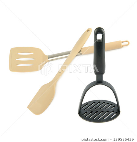 Set of kitchen spatulas and potato masher isolated on white background. 129556439