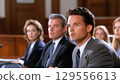 Business meeting with professionals listening attentively in a formal conference room 129556613