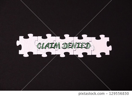 Puzzle with the words claim denied written on it Puzzle with the words claim denied written on it 129556830