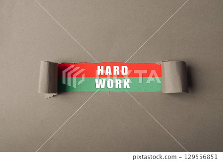 Torn piece of paper with the words hard work written on it Torn piece of paper with the words hard work written on it 129556851