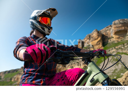 Unrecognizable man with bicycle. Mountain biker stands after riding through summer mountain landscape. Outdoor sports 129556991